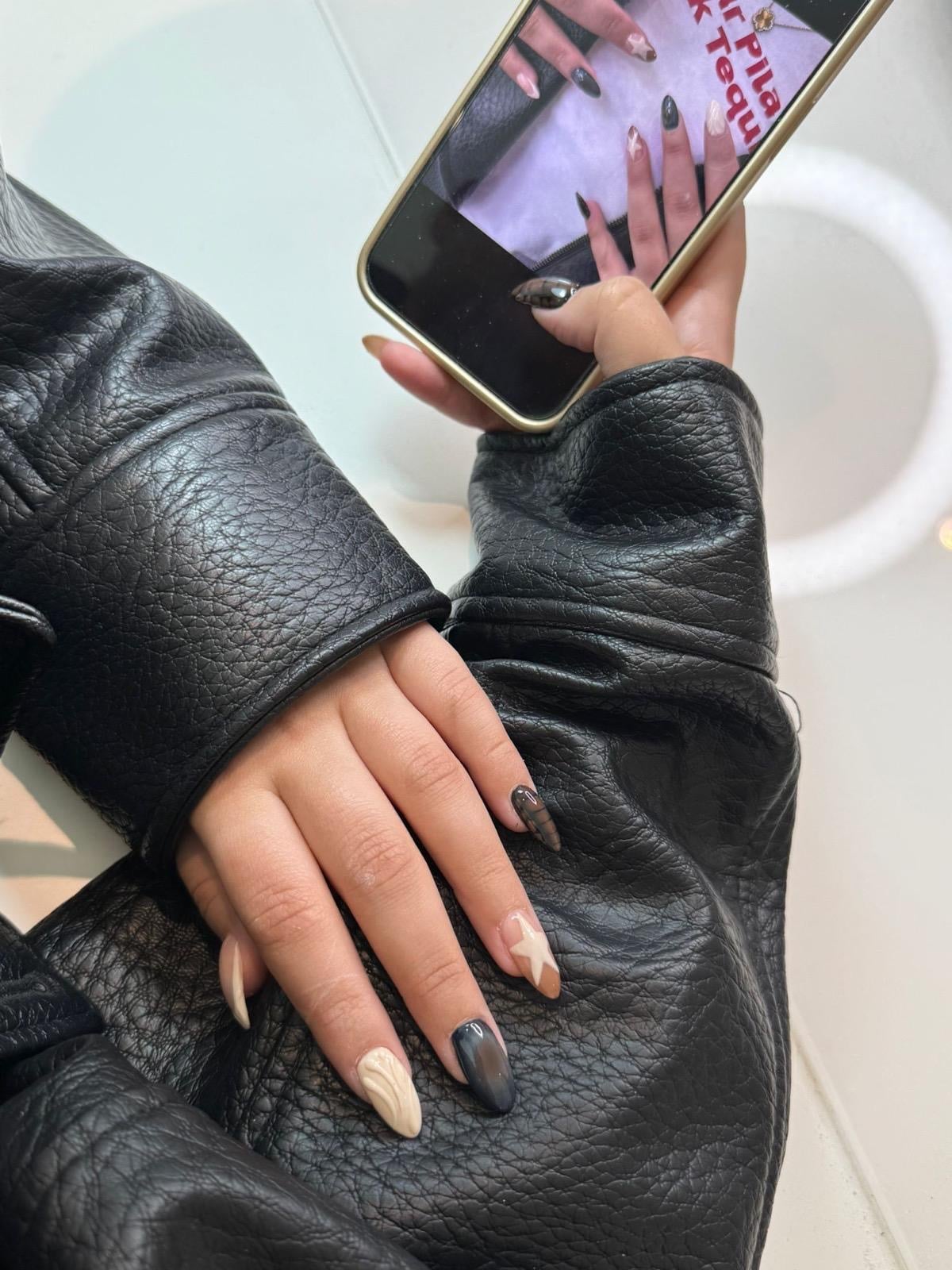 Black and cream nails with a star and sculpted detail